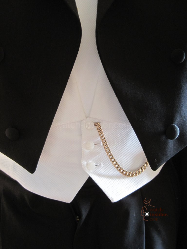 Pocket replica watch with its key chain is attached to the white vest of the tailcoat. Picture found @ uhrforum.de